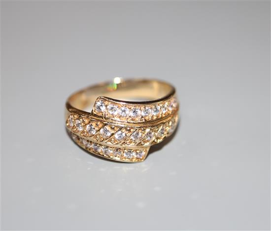 A modern 585 yellow metal and three row diamond set dress ring, size W, gross 5.2 grams.